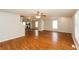 Bright living room with hardwood floors, neutral walls, ceiling fan, and an open view into the modern kitchen at 1112 Smith St, Atlanta, GA 30310