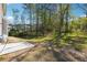 Spacious backyard with green grass and scattered trees at 2860 Windsor Knoll Dr, Dacula, GA 30019