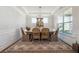 Comfortable dining area offers hardwood floors, natural light, and modern decor at 2860 Windsor Knoll Dr, Dacula, GA 30019