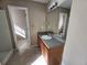 Bathroom features wood cabinets with a stone countertop and a bright mirror at 378 Durmire Dr, Jonesboro, GA 30236