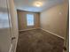 A sunlit bedroom featuring carpeted floors, neutral walls, and a bright window at 378 Durmire Dr, Jonesboro, GA 30236