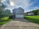 Charming two-story home featuring a two-car garage, stone accents, and a well-manicured lawn at 378 Durmire Dr, Jonesboro, GA 30236