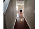 Inviting hallway featuring beautiful wood floors leading to a cozy living room with fireplace at 378 Durmire Dr, Jonesboro, GA 30236