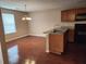 Eat-in kitchen with wooden cabinets, stainless sink and appliances, and a bright dining area at 378 Durmire Dr, Jonesboro, GA 30236