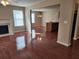 Open-concept living space with hardwood floors, fireplace, and a view into the adjacent kitchen area at 378 Durmire Dr, Jonesboro, GA 30236