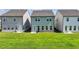 Backyard view showcasing a green lawn and the rear of multiple homes at 4583 Roskin St, Duluth, GA 30097
