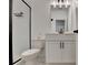This bathroom features a modern vanity, toilet, and black-trimmed shower, creating a stylish and functional space at 4583 Roskin St, Duluth, GA 30097