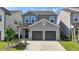 Charming two-story home with a two-car garage and beautifully landscaped front yard under a bright blue sky at 4583 Roskin St, Duluth, GA 30097
