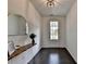 Inviting foyer with dark hardwood floors, a stylish mirror, decorative table and clear view of the front door at 4583 Roskin St, Duluth, GA 30097
