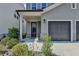 Close-up view of the front entrance with a black front door and manicured landscaping, offering great curb appeal at 4583 Roskin St, Duluth, GA 30097