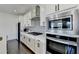 Modern kitchen featuring stainless steel appliances, white cabinetry, and sleek countertops at 4583 Roskin St, Duluth, GA 30097