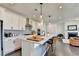 A modern kitchen with white cabinets, stainless steel appliances, an island with seating, and an open floor plan at 4583 Roskin St, Duluth, GA 30097