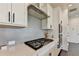 This stylish kitchen has white cabinets, stainless steel appliances, and a sleek backsplash at 4583 Roskin St, Duluth, GA 30097