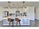 This kitchen is modern with white cabinets, stainless steel appliances, an island with seating, and pendant lighting at 4583 Roskin St, Duluth, GA 30097