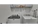 Functional laundry room with washer, dryer, and overhead storage shelves at 4583 Roskin St, Duluth, GA 30097