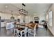 Open-concept living space with a modern kitchen, dining area, and living room with a fireplace at 4583 Roskin St, Duluth, GA 30097