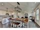 Stylish open-concept living area with a modern kitchen, dining table, and a cozy living room with hardwood floors at 4583 Roskin St, Duluth, GA 30097