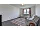 The living room includes a striped rug, a comfortable reclining chair, and a plush sofa, creating a cozy and inviting space at 4583 Roskin St, Duluth, GA 30097