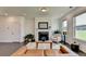 Bright and airy living room featuring a fireplace, hardwood floors, and large windows offering natural light at 4583 Roskin St, Duluth, GA 30097