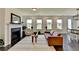 Bright living room featuring a cozy fireplace, large windows, hardwood floors, and a comfortable leather couch at 4583 Roskin St, Duluth, GA 30097