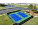 Aerial view of community tennis courts with well-maintained blue playing surface and green surround at 4583 Roskin St, Duluth, GA 30097