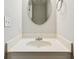 The bathroom features a vanity with countertop and round mirror and towel rack at 658 Slew Ave, Lawrenceville, GA 30043
