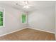 This bedroom features neutral walls, carpet flooring, a ceiling fan, and a bright window at 658 Slew Ave, Lawrenceville, GA 30043