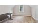 A carpeted bedroom with neutral walls features a window for natural light and desk at 658 Slew Ave, Lawrenceville, GA 30043