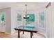 Dining area with new wood-look floors, bright windows, and a stylish chandelier at 658 Slew Ave, Lawrenceville, GA 30043
