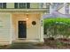 Inviting front entrance featuring a black door with a sidelight and manicured landscaping at 658 Slew Ave, Lawrenceville, GA 30043