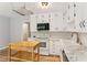 Kitchen with white cabinets, marble countertops, and stainless-steel appliances at 658 Slew Ave, Lawrenceville, GA 30043