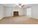 Spacious living room with fireplace, neutral carpet, and ceiling fan at 658 Slew Ave, Lawrenceville, GA 30043