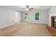 Large living room with fireplace, two windows, and neutral carpet at 658 Slew Ave, Lawrenceville, GA 30043