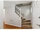 Carpeted staircase with white railing and neutral walls at 658 Slew Ave, Lawrenceville, GA 30043