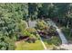 Aerial view of a home with a long driveway, mature landscaping and wooded surroundings at 1590 Sunnybrook Farm Rd, Atlanta, GA 30350