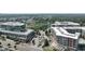 Aerial view of a complex with parking, commercial space, apartments, and a community pool at 1590 Sunnybrook Farm Rd, Atlanta, GA 30350