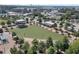 Aerial view of a neighborhood park, featuring a large open green space with trees, walkways, and community buildings at 1590 Sunnybrook Farm Rd, Atlanta, GA 30350