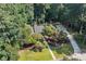 Aerial shot showcasing the front of the house with a long driveway and mature trees at 1590 Sunnybrook Farm Rd, Atlanta, GA 30350