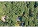 Aerial view of the home nestled among lush trees, revealing the property's wooded privacy at 1590 Sunnybrook Farm Rd, Atlanta, GA 30350