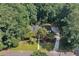 Aerial view of a charming home nestled among lush greenery and mature trees, featuring a long driveway at 1590 Sunnybrook Farm Rd, Atlanta, GA 30350