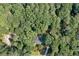 Aerial view of home, set amongst a dense and mature tree surround at 1590 Sunnybrook Farm Rd, Atlanta, GA 30350