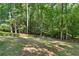 Expansive backyard featuring mature trees and landscaping at 1590 Sunnybrook Farm Rd, Atlanta, GA 30350