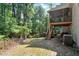 Backyard featuring a screened porch, stairs to the yard, and mature trees at 1590 Sunnybrook Farm Rd, Atlanta, GA 30350
