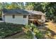 Home featuring a multi-level deck, screened in porch, and tiered backyard landscaping at 1590 Sunnybrook Farm Rd, Atlanta, GA 30350