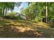 Backyard view of the home showing the lush landscaping and natural surroundings at 1590 Sunnybrook Farm Rd, Atlanta, GA 30350