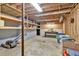 Unfinished basement with wood framing, concrete floor, exposed ceiling, and ample room for storage at 1590 Sunnybrook Farm Rd, Atlanta, GA 30350
