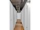 Hallway with exposed ceiling and wood-look flooring at 1590 Sunnybrook Farm Rd, Atlanta, GA 30350