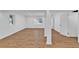 Finished basement featuring hardwood floors, white trim, and two windows providing natural light at 1590 Sunnybrook Farm Rd, Atlanta, GA 30350