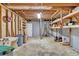 Spacious unfinished basement featuring concrete floor, storage shelving, exposed ceiling, and work area at 1590 Sunnybrook Farm Rd, Atlanta, GA 30350
