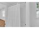 Tile lined shower and curtain inside a bathroom with a window at 1590 Sunnybrook Farm Rd, Atlanta, GA 30350